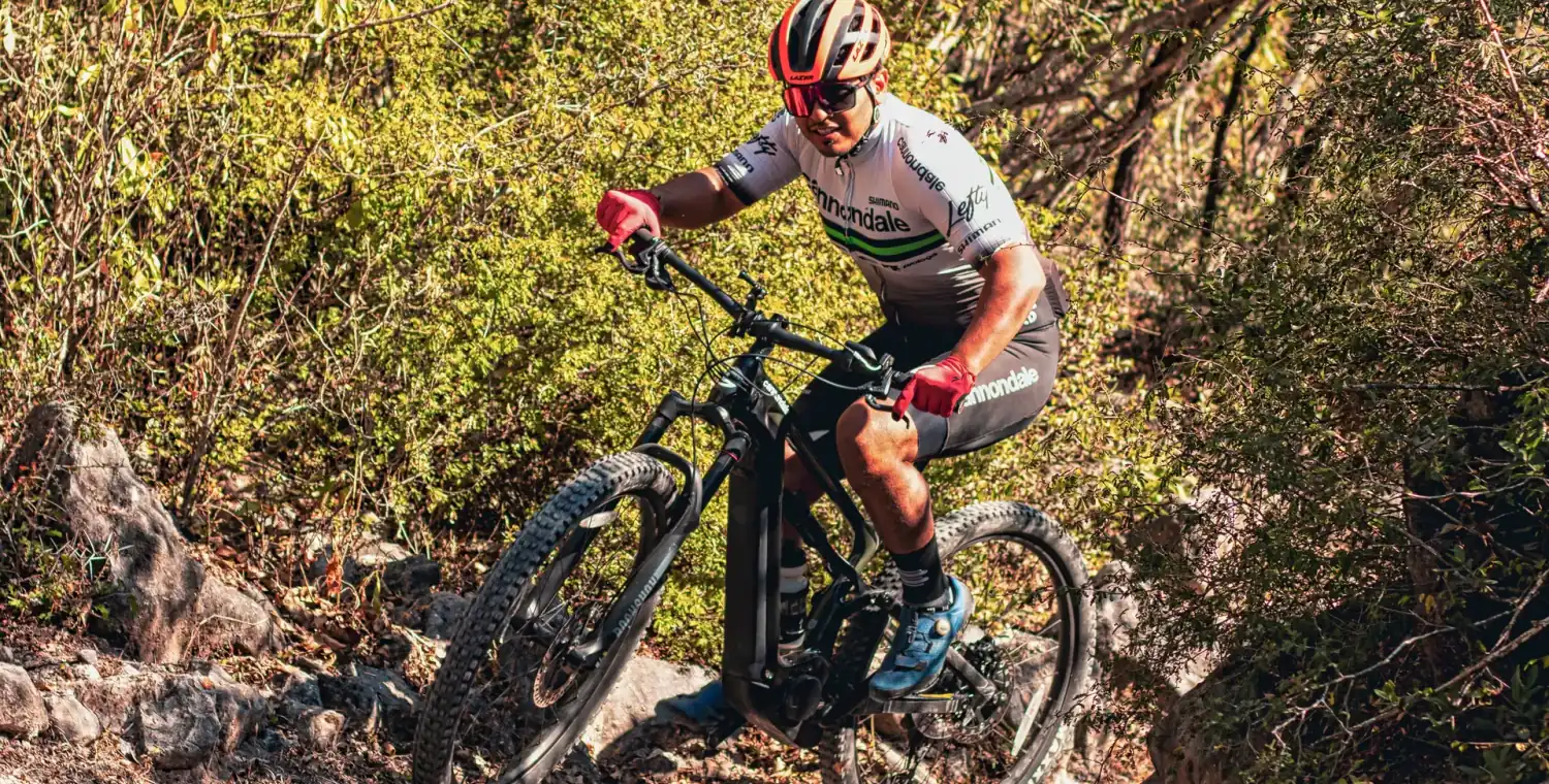 Electric mountain bike on a UK trail — full-suspension eMTB riding through woodland