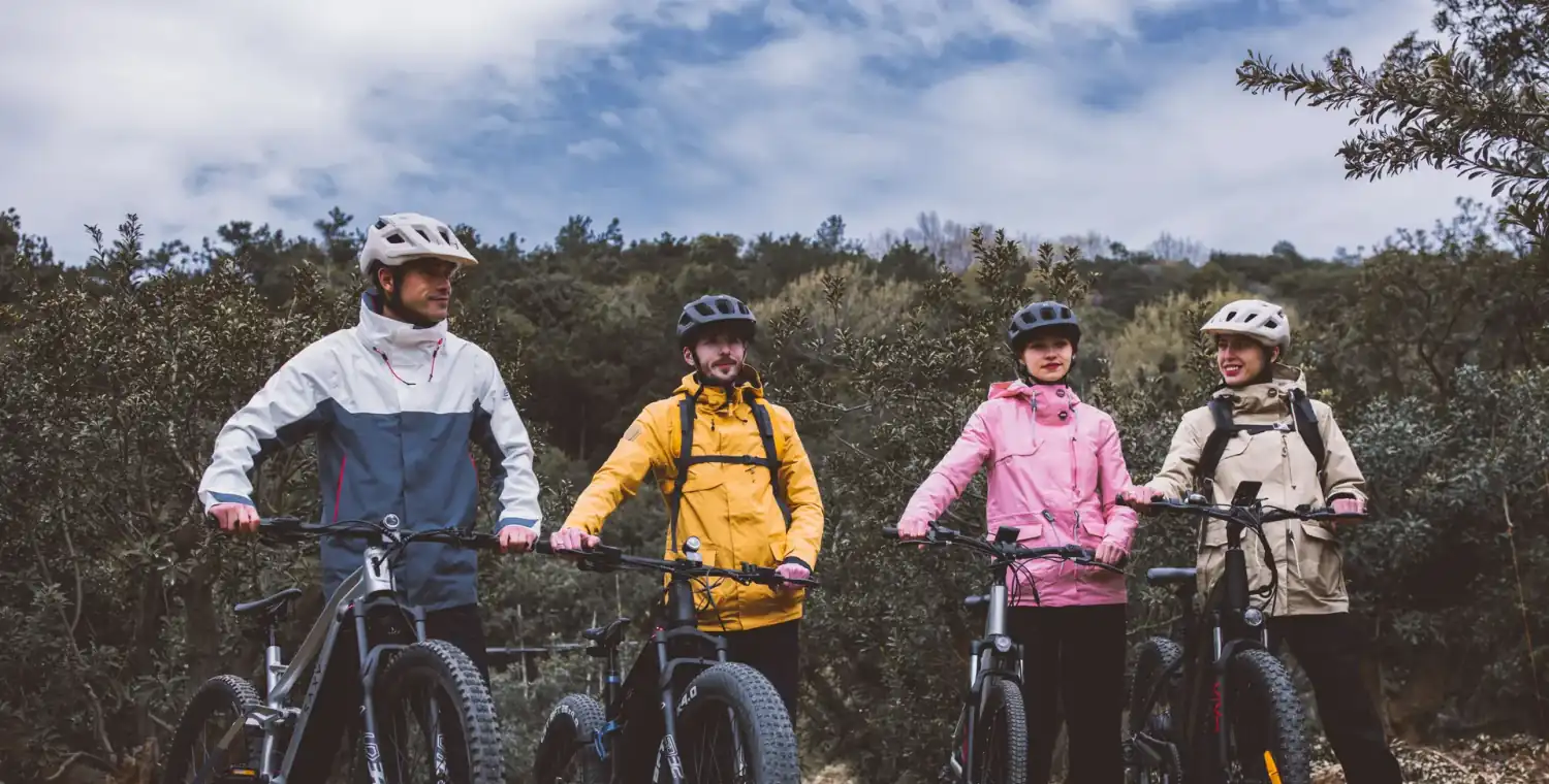 Rider on an electric mountain bike climbing a steep UK hillside trail